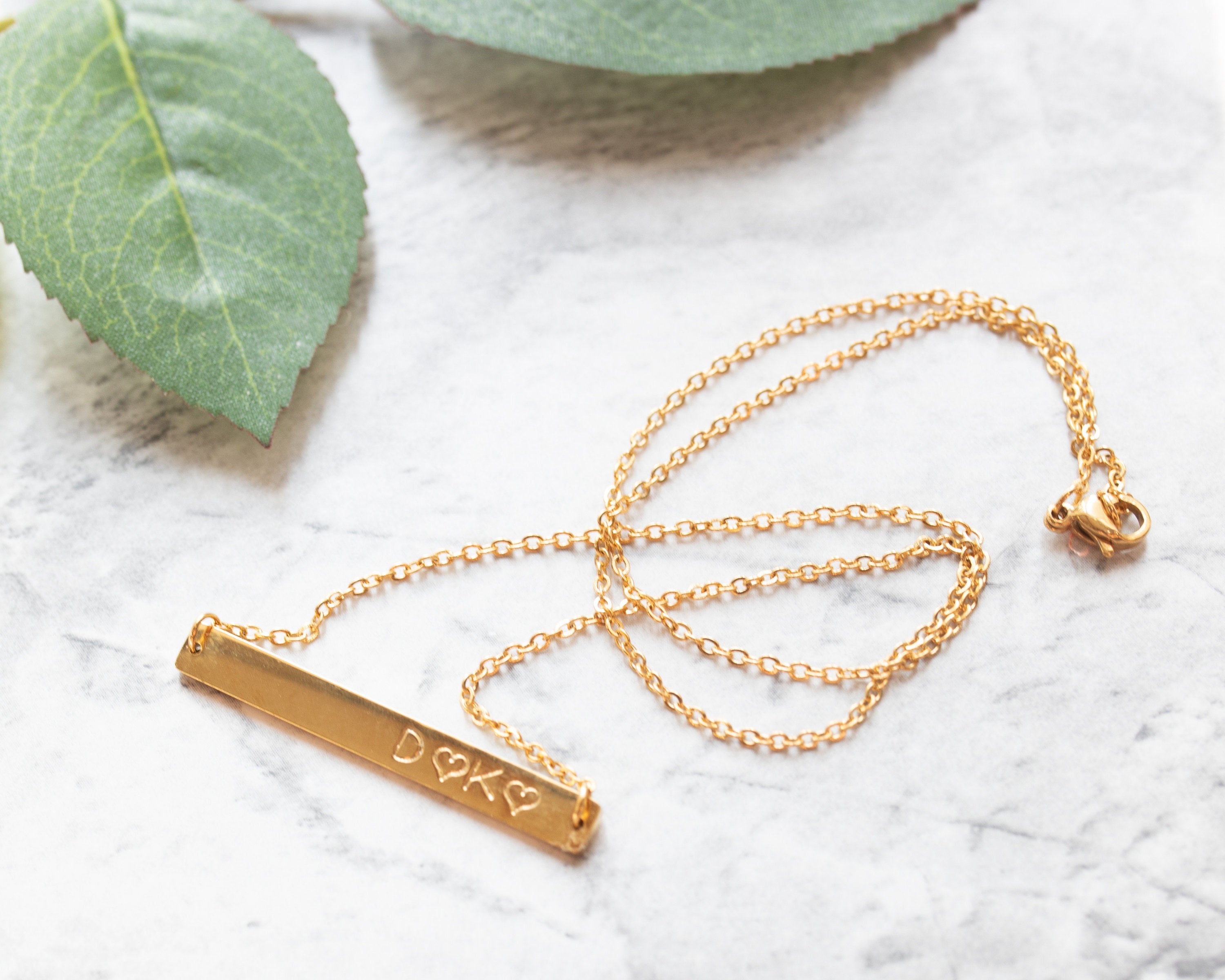 gold bar necklace with custom stamped message